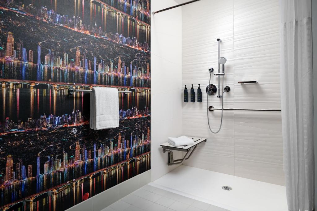 Queen Room with Two Queen Beds Mobility and Hearing Accessible Transfer Shower